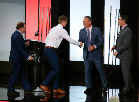 Andrei Svechnikov of Canada shakes hands with team