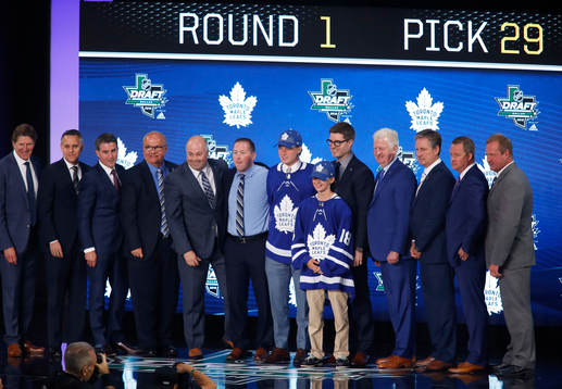 Rasmus Sandin poses with team representatives