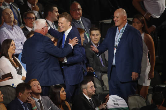 Brady Tkachuk hugs family members