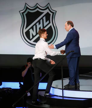 Jesperi Kotkaniemi of Finland is greeted by NHL
