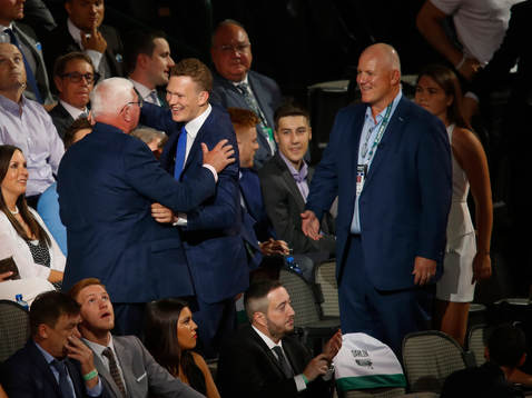 Brady Tkachuk hugs family members