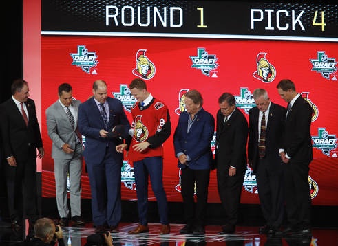 Brady Tkachuk shakes hands with team representatives