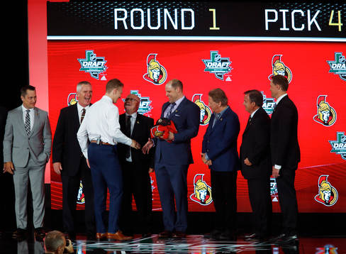 Brady Tkachuk shakes hands with team representatives