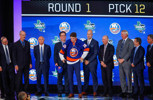 Noah Dobson of Canada poses with team representatives