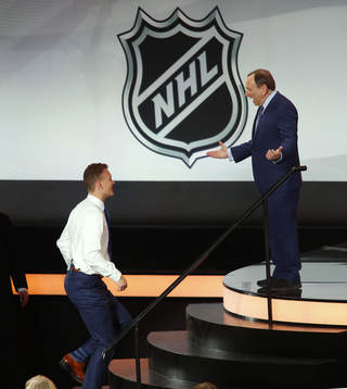 Brady Tkachuk is greeted by NHL Commissioner Gary Bettman