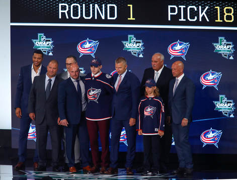 Liam Foudy of Canada poses with team representatives