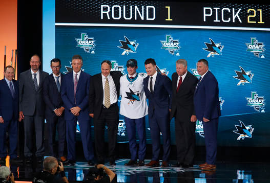 Ryan Merkley of Canada poses with team representatives
