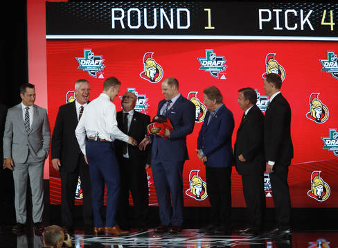 Brady Tkachuk shakes hands with team representatives