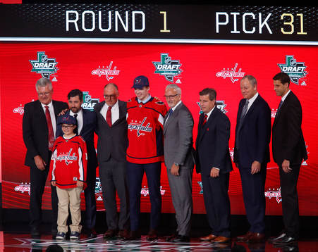 Alexander Alexeyev of Russia poses with team representatives