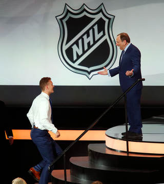 Brady Tkachuk is greeted by NHL Commissioner Gary Bettman