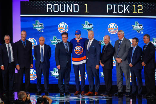 Noah Dobson of Canada poses with team representatives