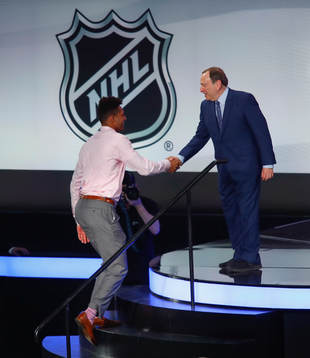 K'Andre Miller of the United States is greeted by NHL