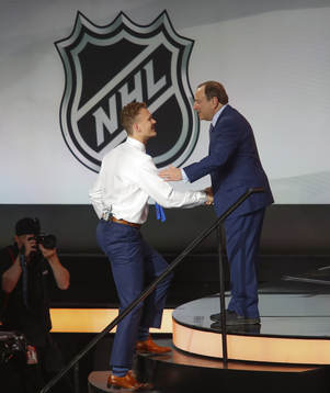 Brady Tkachuk is greeted by NHL Commissioner Gary Bettman