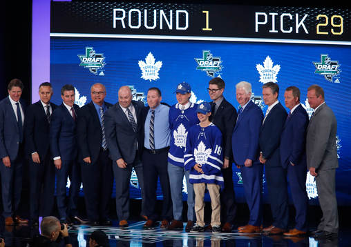 Rasmus Sandin poses with team representatives