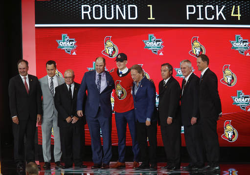 Brady Tkachuk shakes hands with team representatives