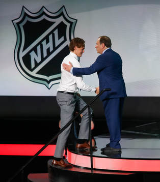 Filip Johansson of Sweden is greeted by NHL Commissioner