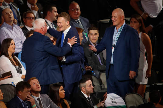 Brady Tkachuk hugs family members
