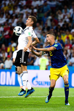 Thomas Müller of Germany and Mikael Lustig of Sweden