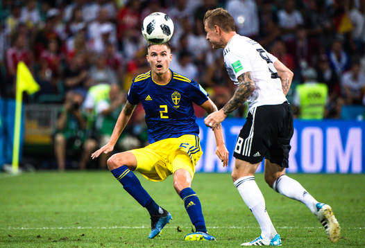 Mikael Lustig of Sweden and  Toni Kroos  of Germany