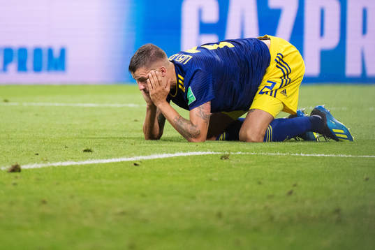 Mikael Lustig of Sweden look dejected