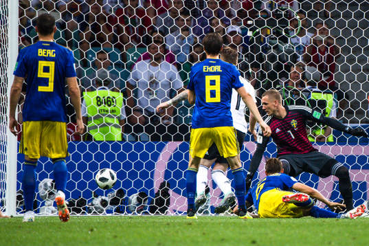 Marco Reus of Germany scores the 1-1 goal behind goalkeeper