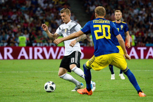 Toni Kroos of Germany and Ola Toivonen of Sweden