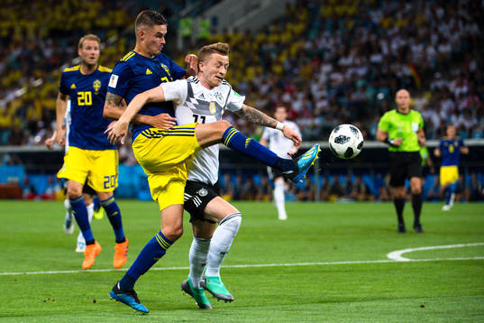 Mikael Lustig of Sweden and Marco Reus of Germany
