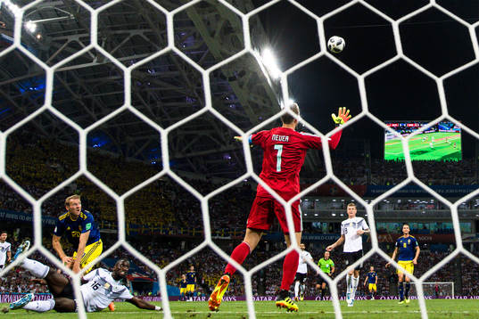 Ola Toivonen of Sweden scores the 1-0 goal behind