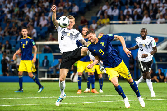 Toni Kroos of Germany and Marcus Berg of Sweden