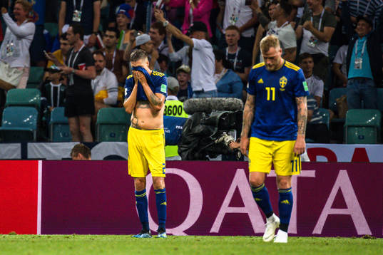 Mikael Lustig and John Guidetti of Sweden looks dejected