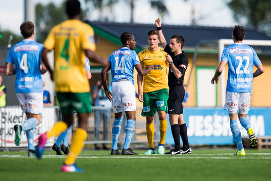 Akinsola Akinyemi of Sandnes Ulf is shown a yellow card by