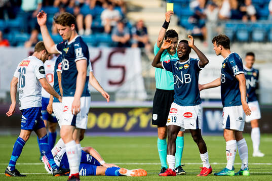 Francisco Júnior of Strømsgodset is shown a yellow card