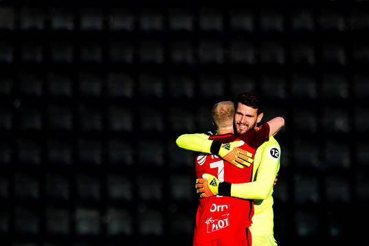 Peter Orry Larsen and goalkeeper Samuel Sahin-Radlinger of