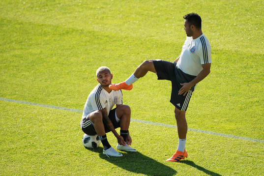 Marco Fabian (R) pretends to kick Jesus Corona (L) of the
