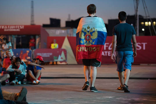 A Russian fan walks through FIFA Fan Fest