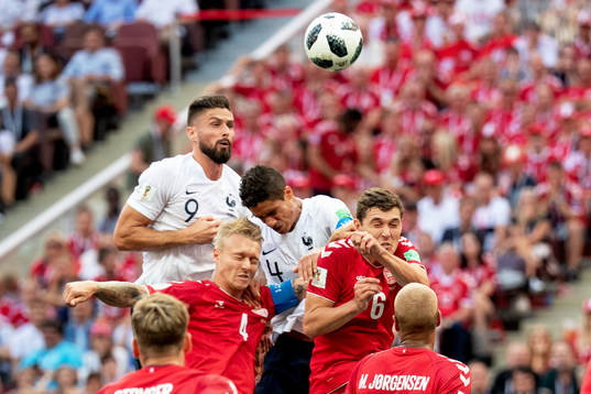Olivier Giroud and Raphael Varane of France and Simon Kjaer