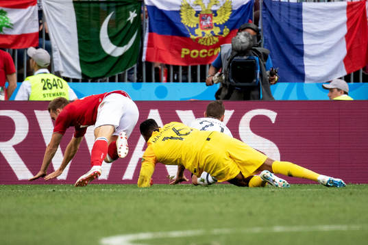 Christian Eriksen of Denmark goes down in the penalty area