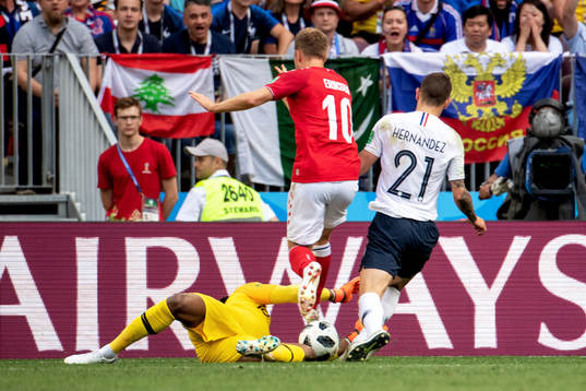 Christian Eriksen of Denmark goes down in the penalty area