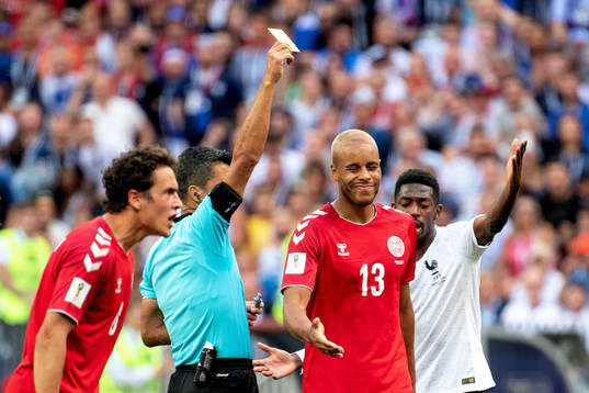 Mathias Jørgensen of Denmark is shown a yellow card