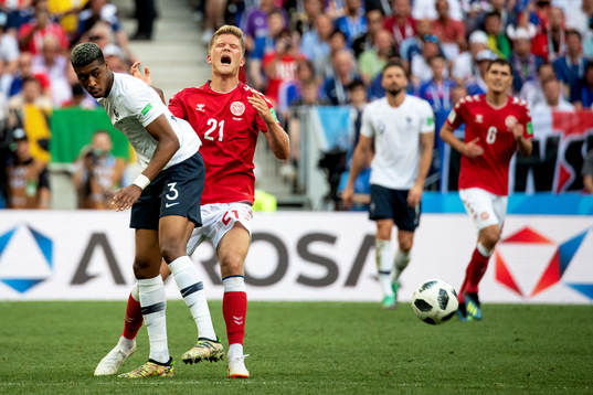 Presnel Kimpembe of France and Andreas Cornelius of Denmark