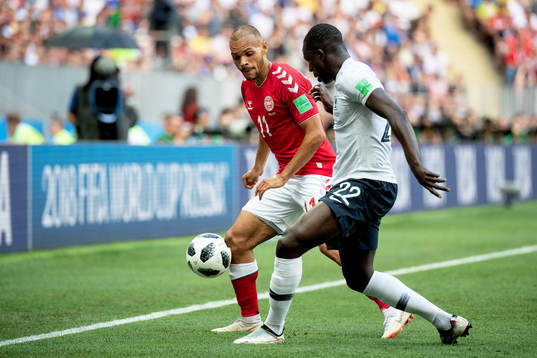 Martin Braithwaite of Denmark and Benjamin Mendy of France
