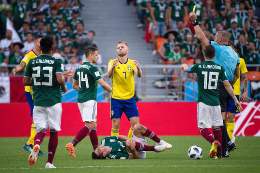 Sebastian Larsson of Sweden receives a yellow card