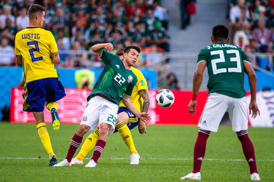 Mikael Lustig of Sweden against Hirving Lozano of Mexico