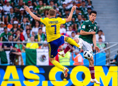 Sebastian Larsson of Sweden and Hirving Lozano of Mexico
