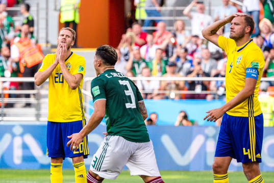 Ola Toivonen and Andreas Granqvist of Sweden looks dejected