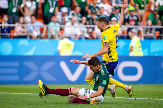 Hector Moreno of Mexico and Marcus Berg of Sweden