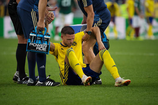 Marcus Berg of Sweden gets help up