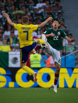 Sebastian Larsson of Sweden and Hirving Lozano of Mexico