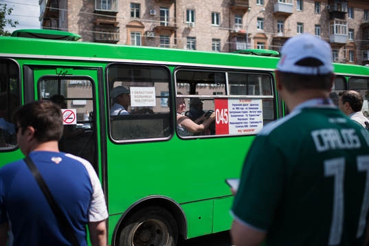 A woman peeks ut from a bus