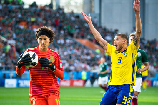 goalkeeper Guillermo Ochoa of Mexico and Marcus Berg of